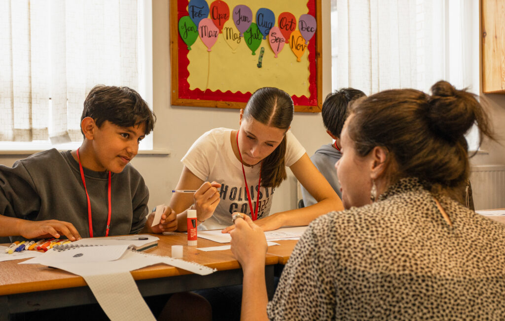 English teacher supporting students at Nacel English School Summer Camp