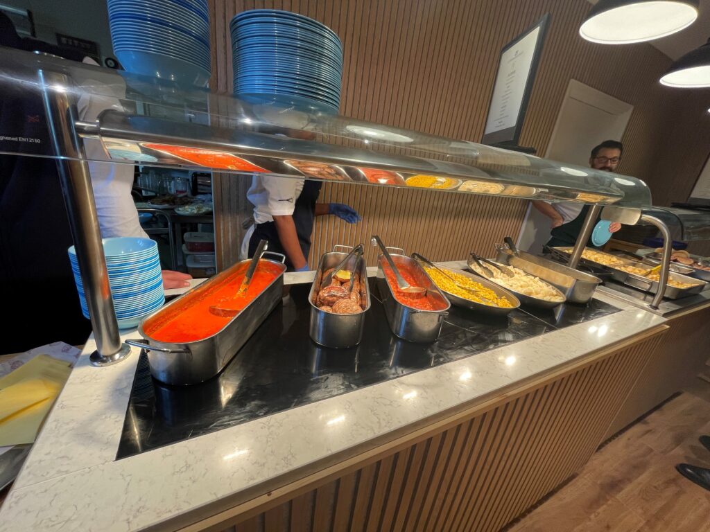 Friendly staff serving dinner at Nacel English Summer Camp cafeteria